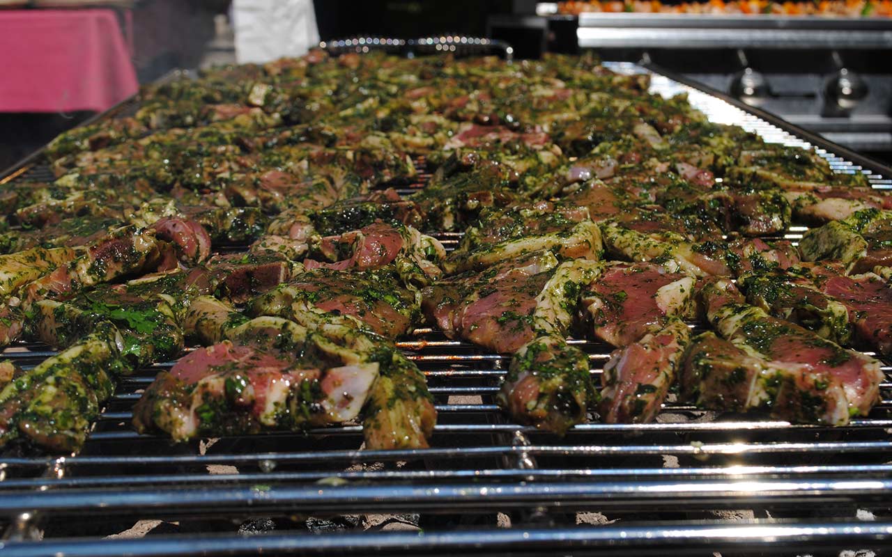 Chops sprinkled with fresh herbs slowly sizzling on the grill